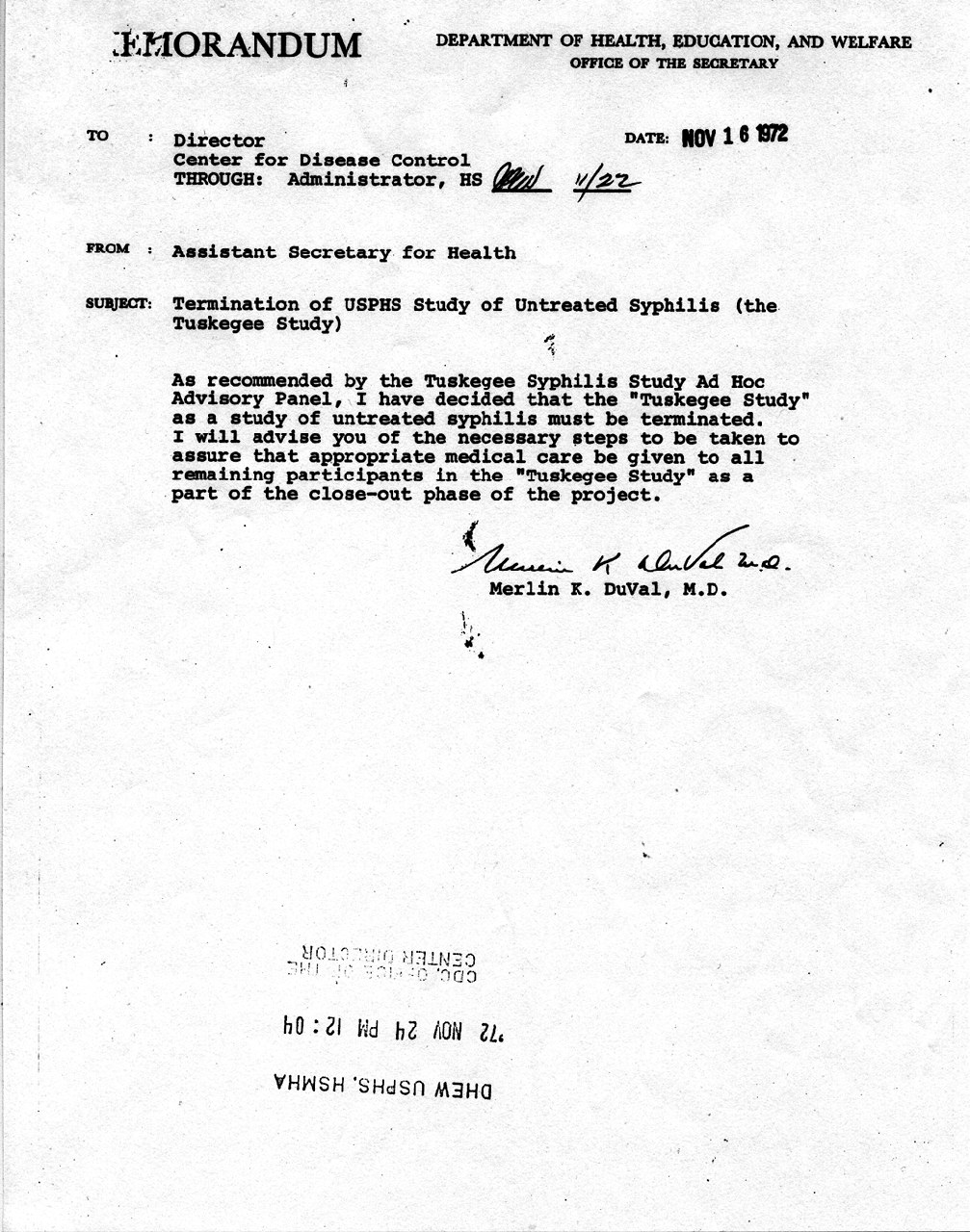 A scan of a single typewritten page in portrait format: a memorandum on Department of Health, Education, and Welfare letterhead with a bold date stamp at the upper right, header lines labelled TO, THROUGH, FROM and SUBJECT, a short paragraph of typewriter text with a handwritten signature above a typed name below it, a large area of blank paper filling the lower half, and a faint upside down office stamp near the foot of the page