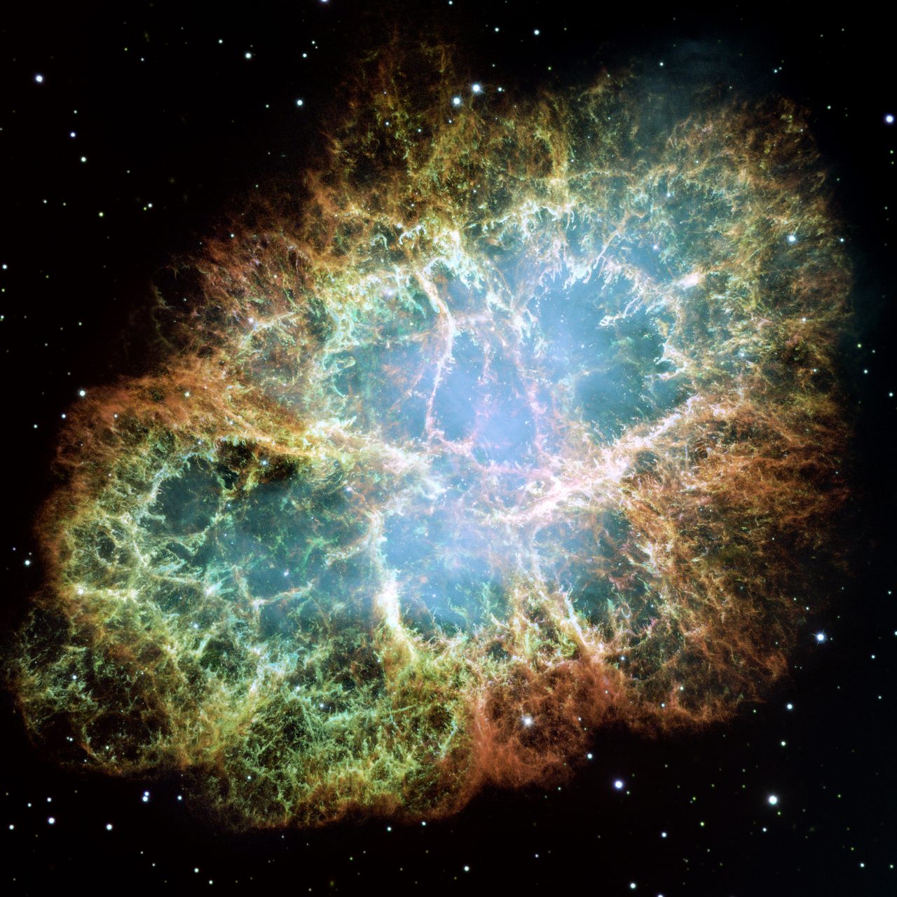 A Hubble Space Telescope mosaic of the Crab Nebula: a roughly oval cloud of filaments against a dark star field