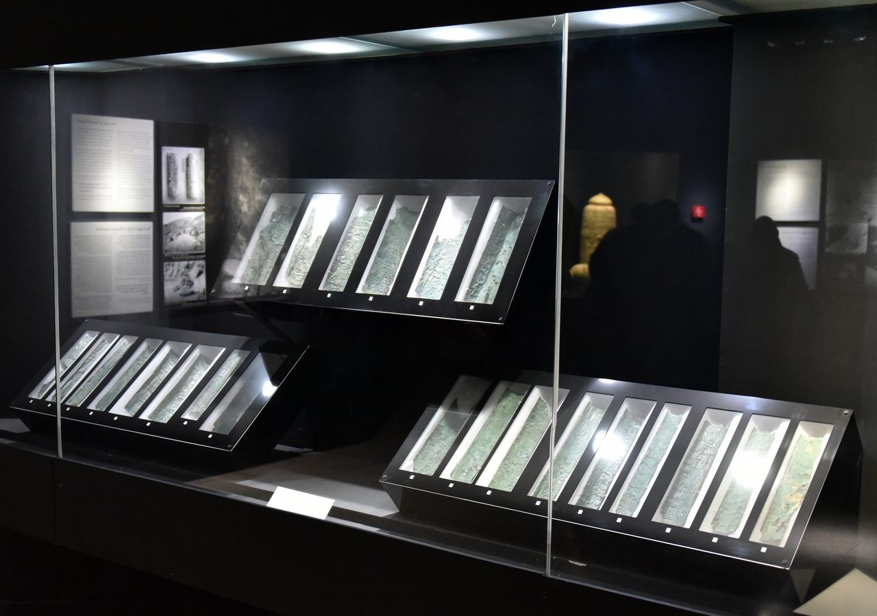 The full Copper Scroll display case at the Jordan Museum, showing multiple of the 23 cut copper strips together