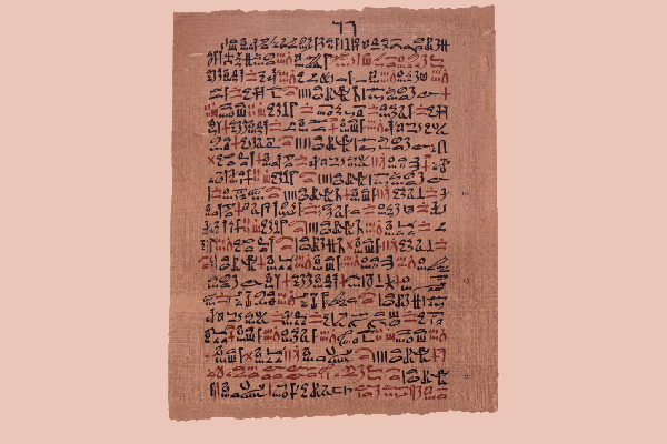A page of hieratic Egyptian script on tan papyrus, written in black ink with headings marked in red