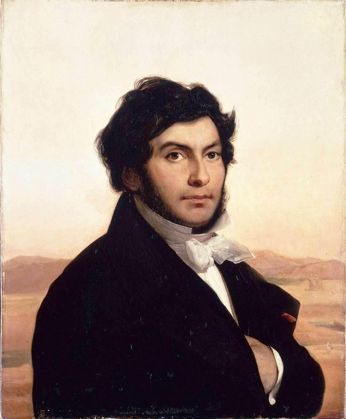 An oil portrait of a young man with dark wavy hair and dark side-whiskers, arms folded, wearing a black coat and a white cravat, with a warm Egyptian desert landscape and distant hills behind him