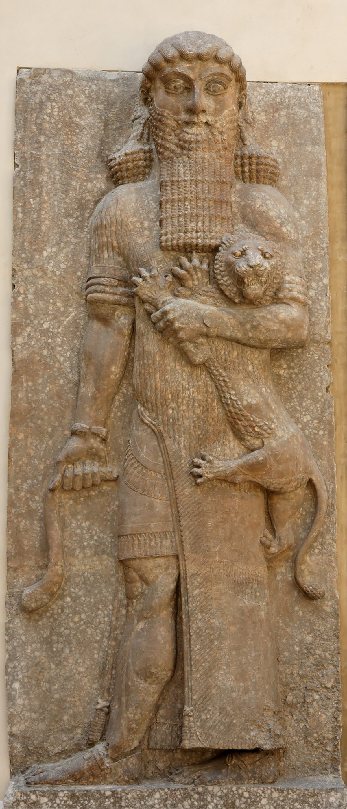 A high relief of a hero figure mastering a lion, from the Palace of Sargon II at Khorsabad, now in the Louvre