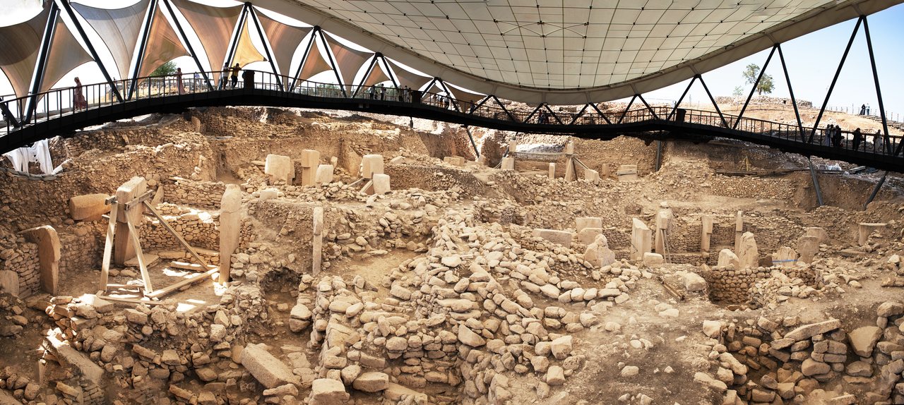 Wide panoramic view of the excavated circular enclosures and T-shaped pillars at Gobekli Tepe