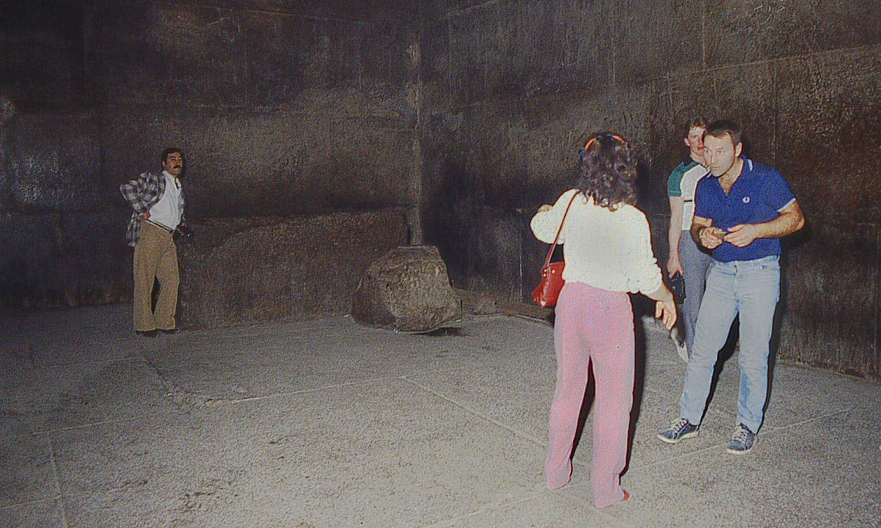 The King's Chamber of the Great Pyramid, walled in red Aswan granite, with the empty granite sarcophagus at the far end