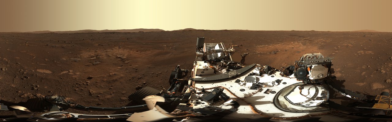 A wide panorama of the Jezero Crater floor and rim on Mars, stitched from rover camera images
