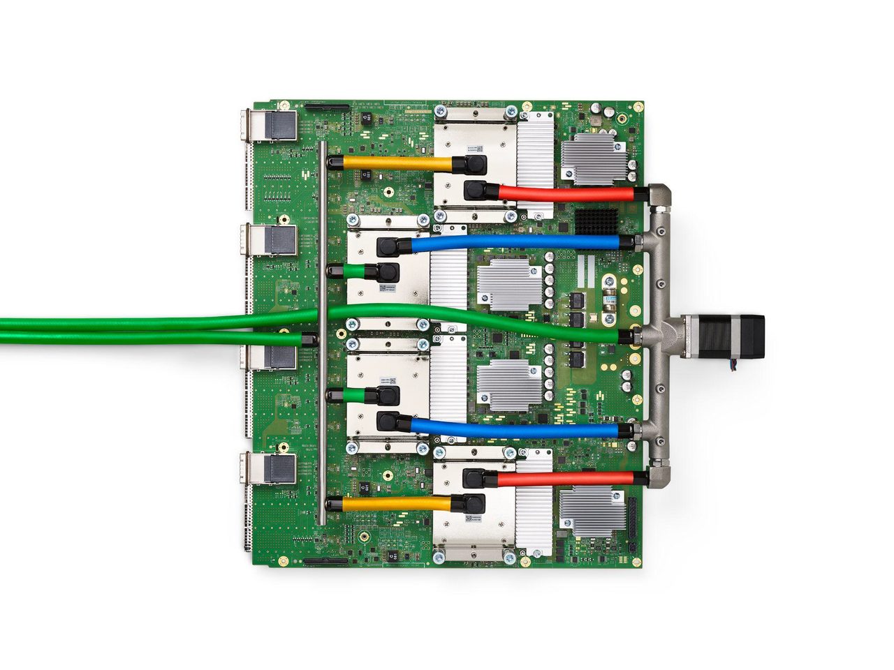 A printed circuit board carrying four liquid-cooled processor packages, each under a white cold plate with quick-disconnect fittings and coloured coolant hoses, with a coolant manifold and an inline pump along one edge
