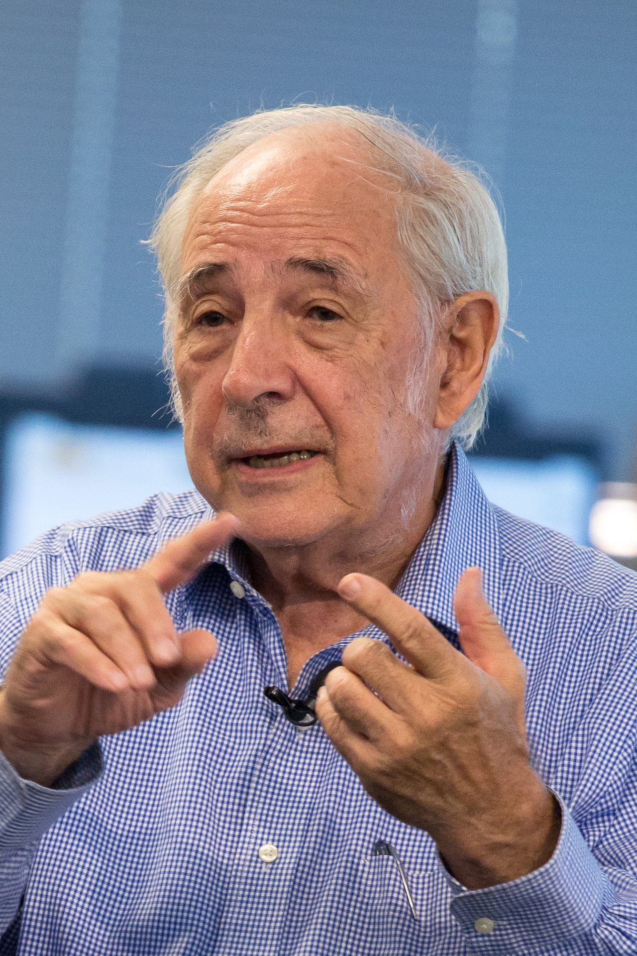 A photograph of the philosopher John Searle giving a talk titled Consciousness in Artificial Intelligence at Google in 2015