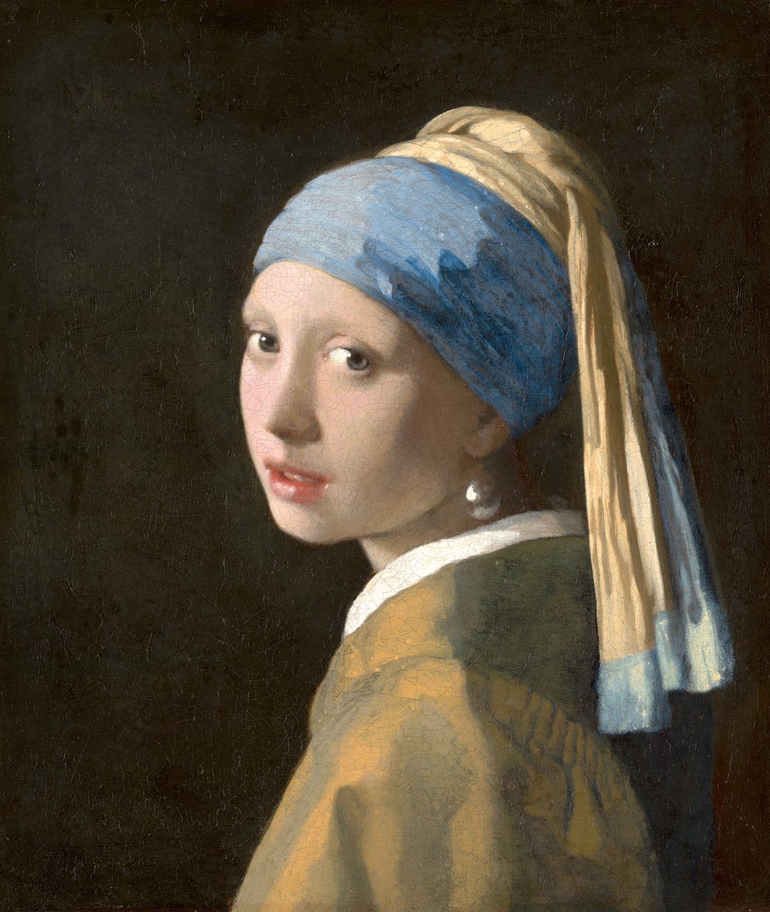 A painted half-length figure of a young woman set against a very dark, plain ground, her body turned away and her head brought round so that she looks straight out of the picture, her lips slightly parted. A cloth is wound about her head with a long tail of fabric falling behind her shoulder, a large pear-shaped pearl hangs at her ear, and a fine network of craquelure runs across the whole paint surface.