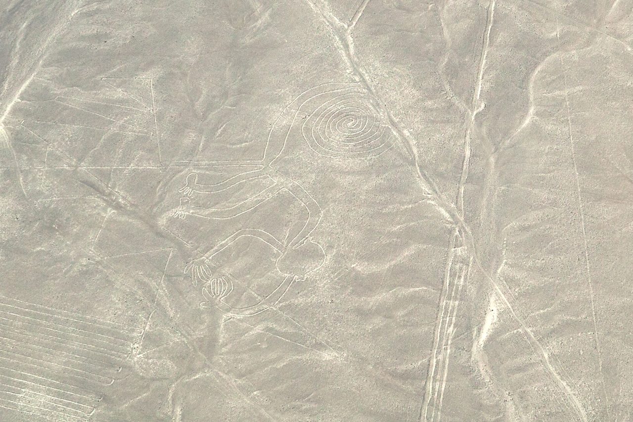 Aerial view of the Nazca monkey geoglyph, a stylized monkey with a large curled tail scraped into the desert floor