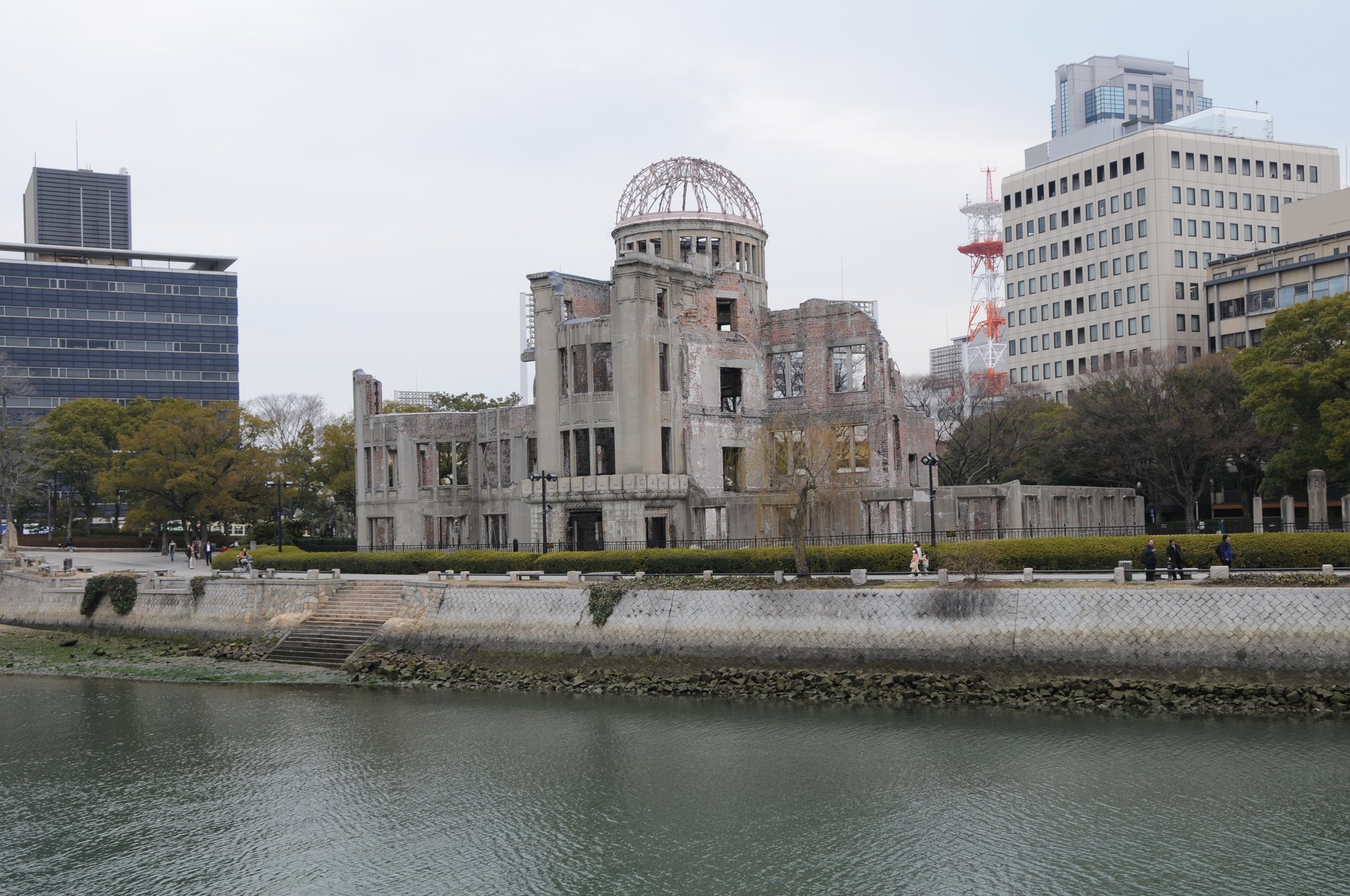 The Genbaku Dome (Hiroshima Peace Memorial): the skeletal, roofless ruin of a domed building left standing near the atomic bomb's hypocenter, preserved beside the river in Hiroshima Peace Memorial Park