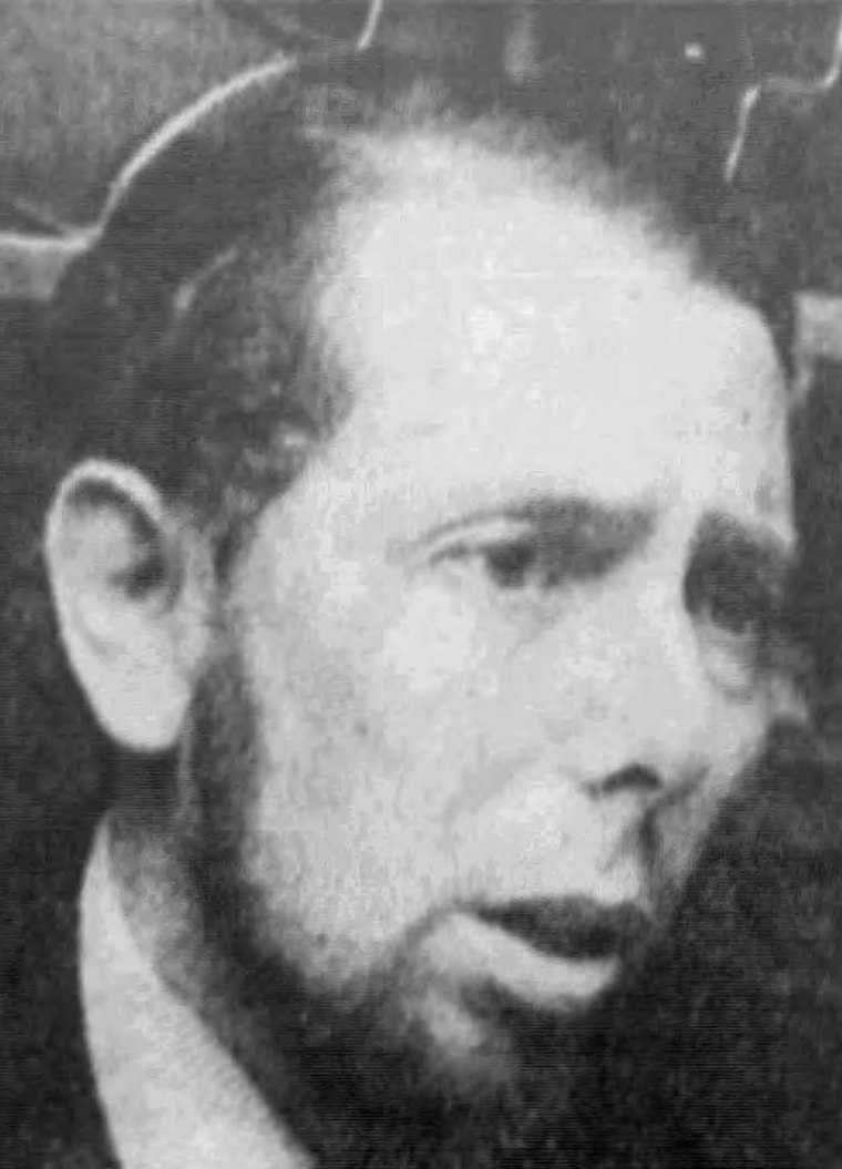 A black-and-white portrait photograph of the psychologist Stanley Milgram, taken in 1974