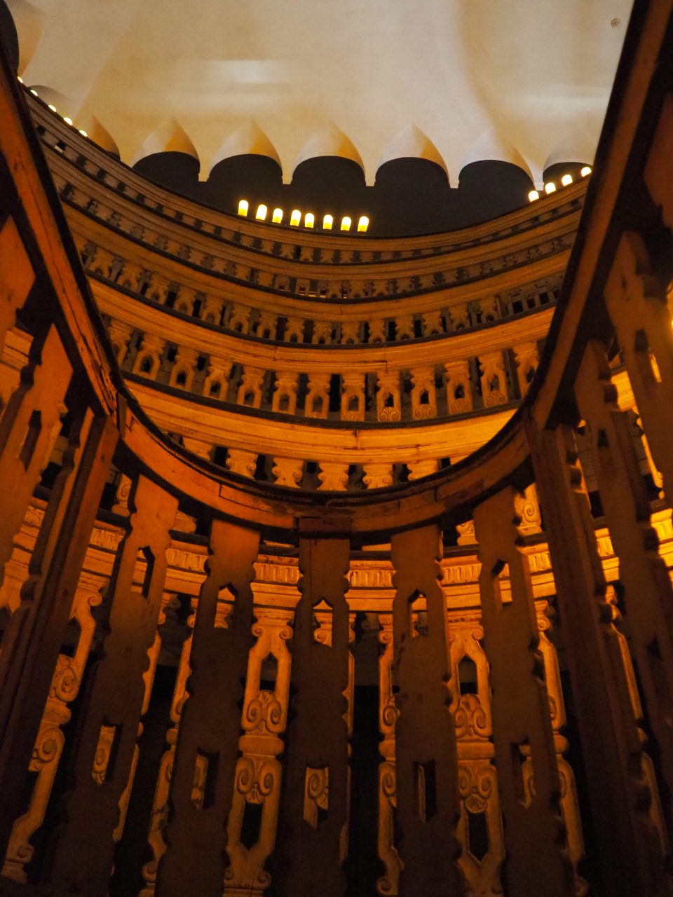 The interior of the anatomical theatre in the Palazzo Bo at the University of Padua, with modern electric lamps fixed along the cornice.
