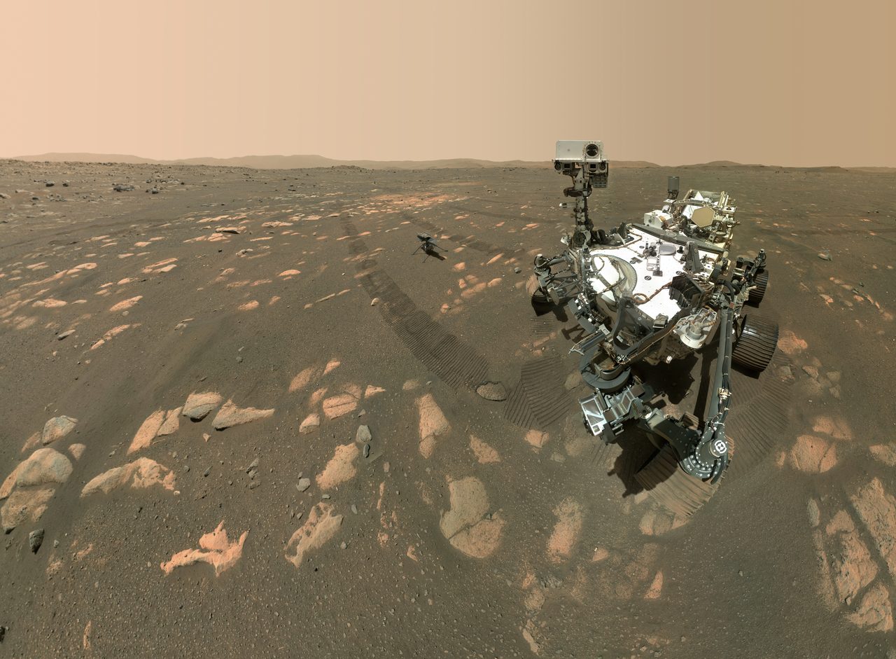 A composite self-portrait of NASA's Perseverance rover on the Martian surface, with the small Ingenuity helicopter visible nearby