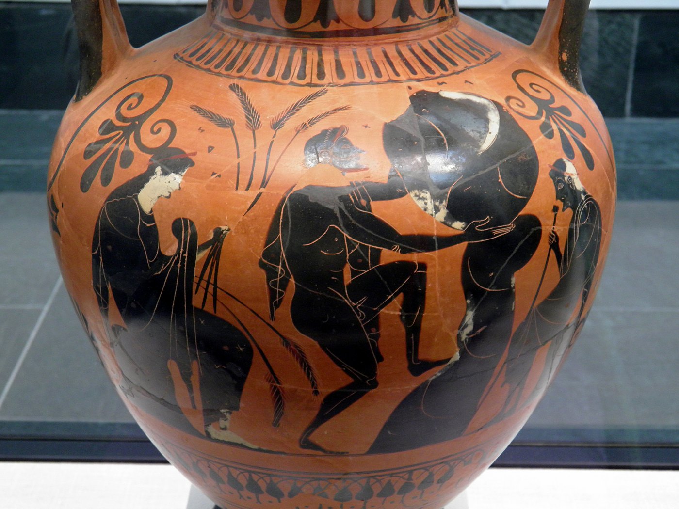 An ancient Greek black-figure amphora showing Sisyphus condemned to roll a boulder up a hill in the underworld, flanked by the deities of the underworld