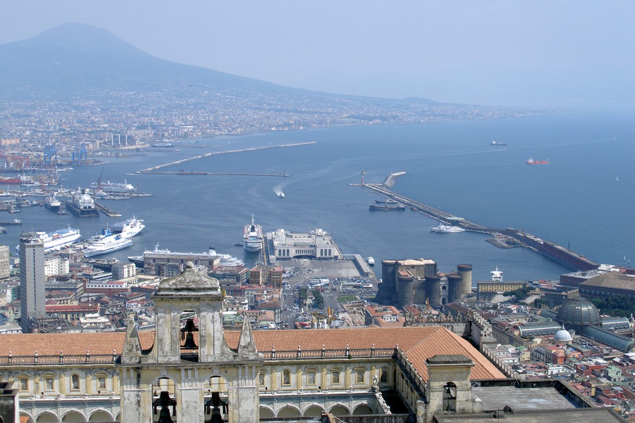 A wide view over the Bay of Naples, the Port of Naples, and Mount Vesuvius rising above the coastline
