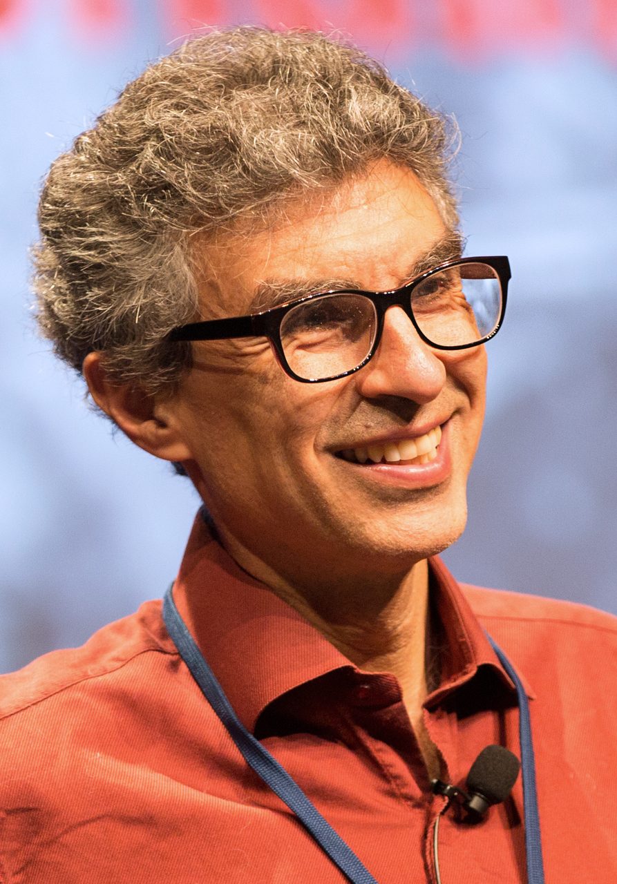 A photograph of Yoshua Bengio giving a presentation